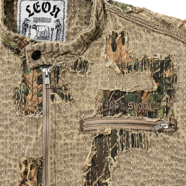 Close-up of Boro Jacket chest showing distressed boro stitching, camo under-layer, and 40s & Shorties embroidery
