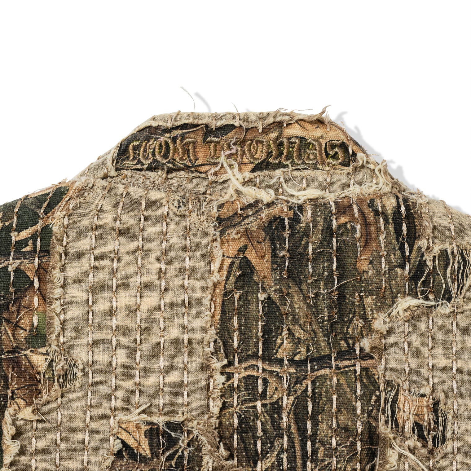Close-up of Boro Jacket collar with frayed detailing and Leon Thomas embroidery
