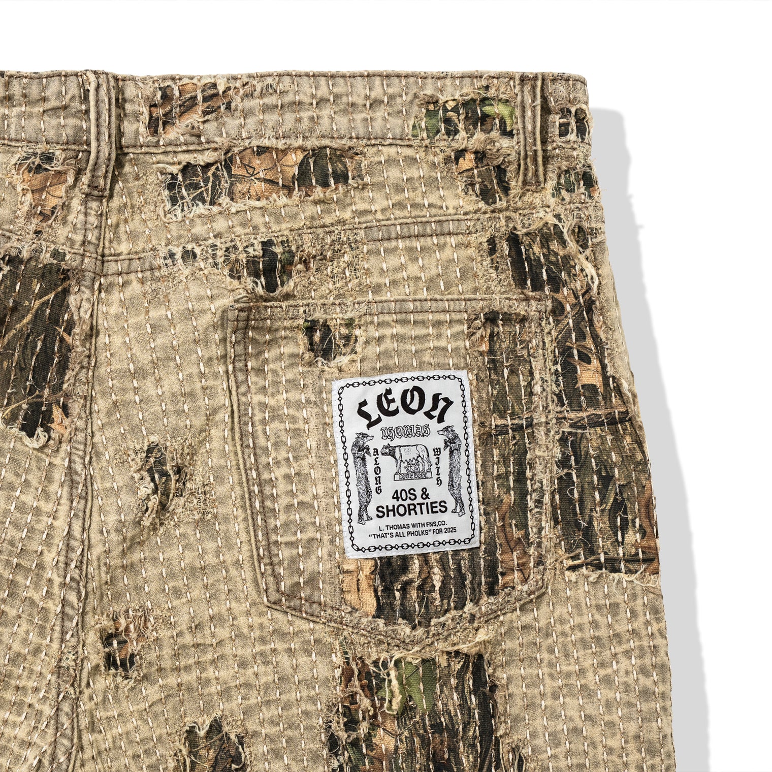 Boro Pants pocket close-up with Leon Thomas x 40s & Shorties woven label and distressed boro stitching
