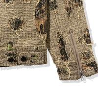 Detail shot of Boro Jacket sleeve hem with distressing, camo under-layer, and YKK zipper
