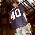 Lifestyle photo: back view of model wearing the Crochet Football Jersey
