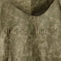 Macro close-up of molded 40s & Shorties back logo on Damien Zip Hoodie – Brown