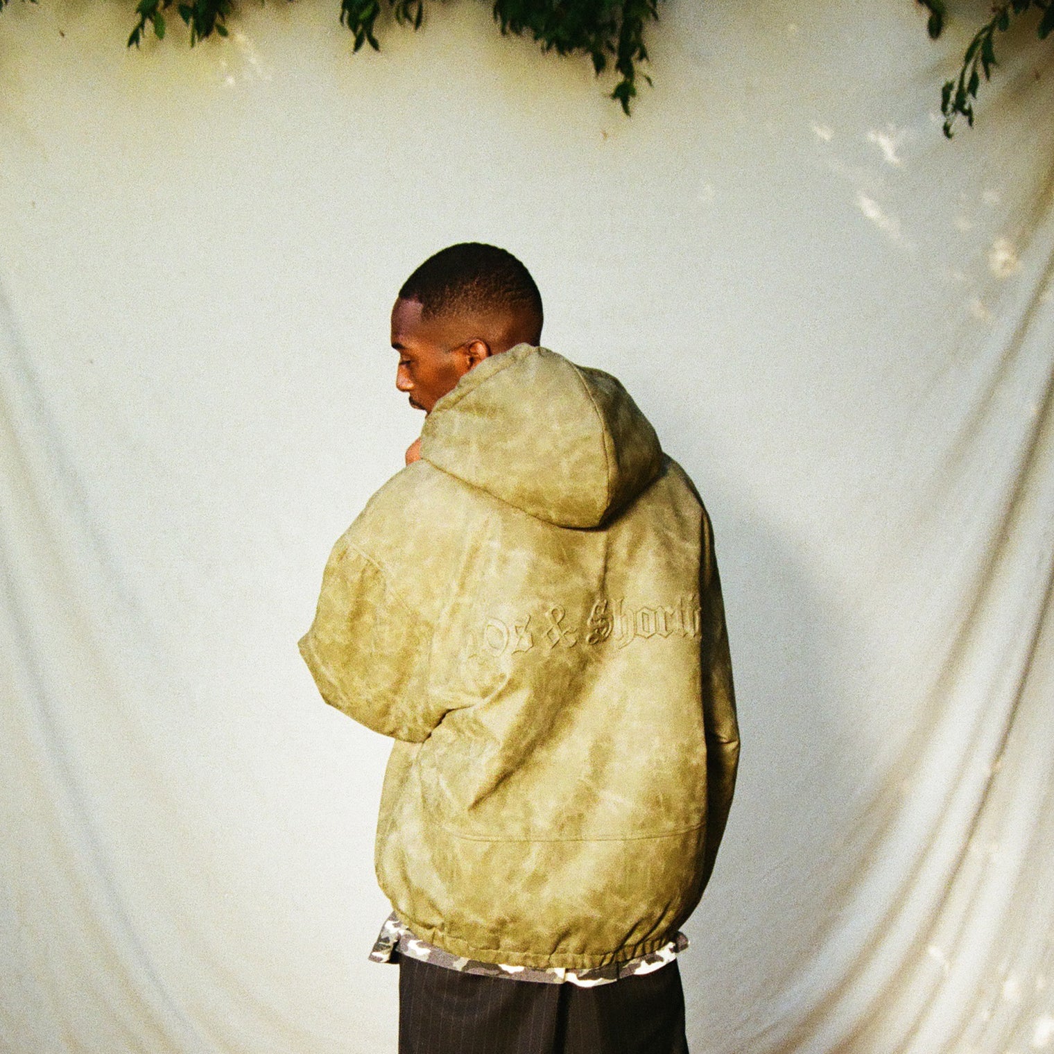 Model back view showing 3D logo on Damien Zip Hoodie – Brown
