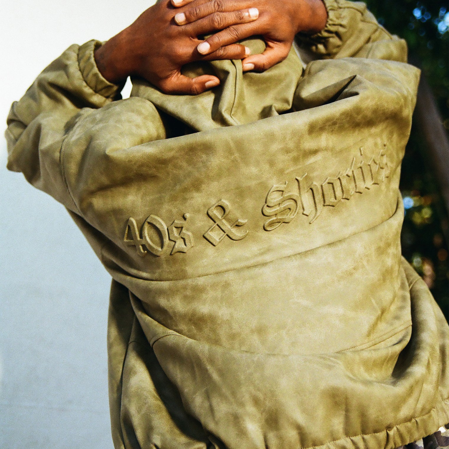 Detailed shot of 3D molded logo on back of Damien Zip Hoodie – Brown
