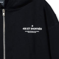 Close-up of front chest graphic reading “40S ET SHORTIÉS” with French text underneath on black hoodie – 40s & Shorties.
