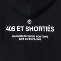 Detailed view of printed “40S ET SHORTIÉS” graphic with French text on back of black hoodie – 40s & Shorties.
