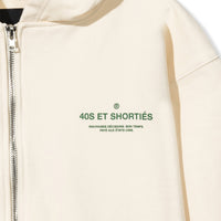 Close-up of front chest graphic reading “40S ET SHORTIÉS” with French text underneath on cream hoodie – 40s & Shorties.
