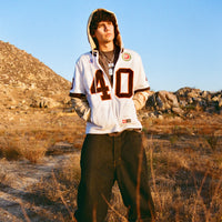 Model standing outdoors in 40s & Shorties Jackson Jersey Sweater Desert Camo with hood up.