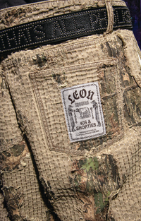 Boro Pants pocket close-up with Leon Thomas x 40s & Shorties woven label, distressed boro stitching, and Leon Thomas Snakeskin Belt
