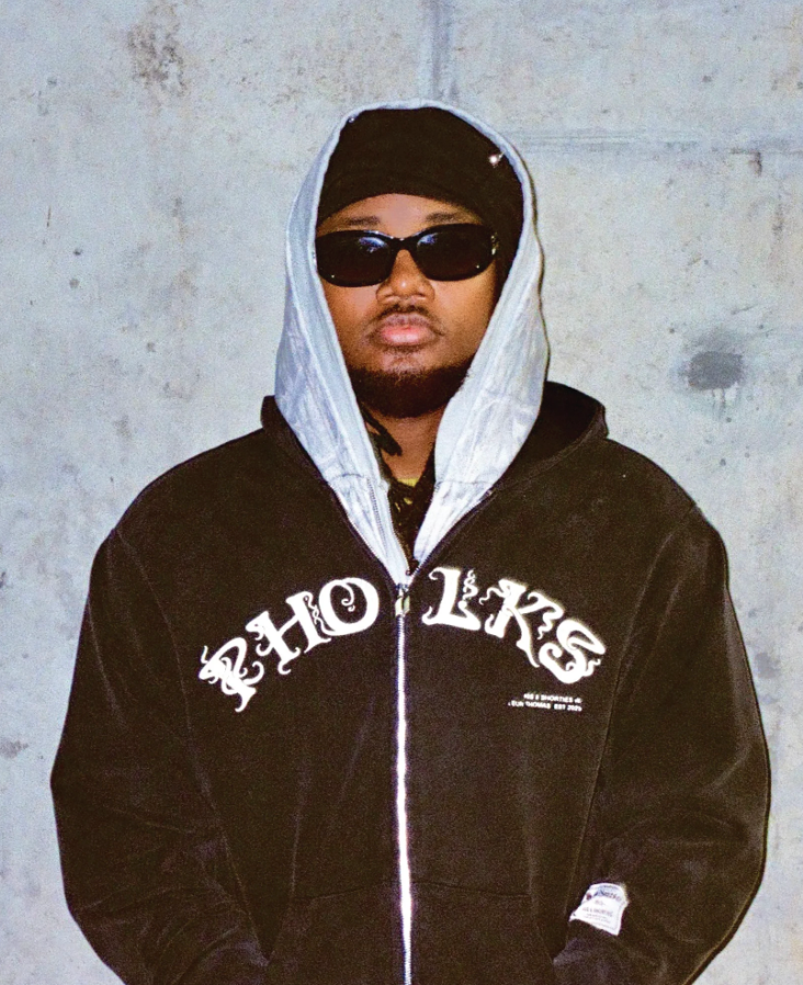 Model standing in Triple Zip Hoodie with layered front panels and zippers
