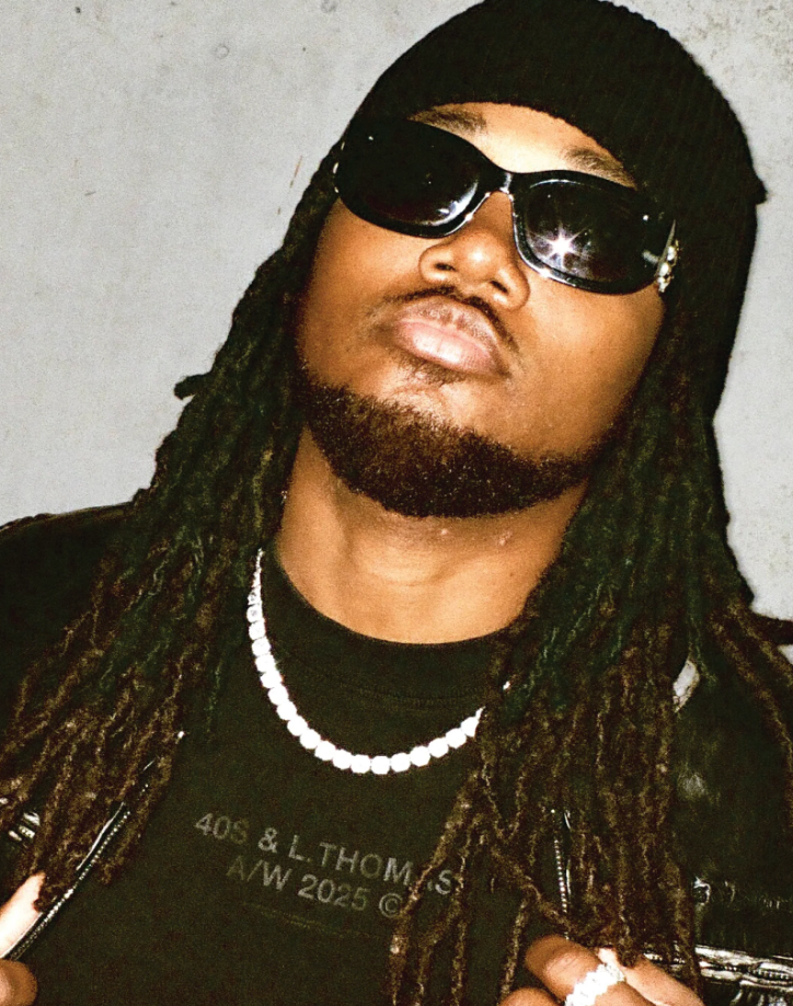 Model wearing Leon General Logo Tee layered under jacket with tonal puff print detail
