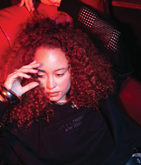 Model wearing Leon General Logo Tee in black styled in a relaxed setting