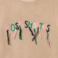 Close-up of hand-stitched 40s & Shorties logo with hanging loose threads in pink, green, white, and black