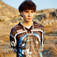 Model wearing 40s & Shorties Tales Hockey Jersey in black with large sublimated skull graphic and chain necklace.
