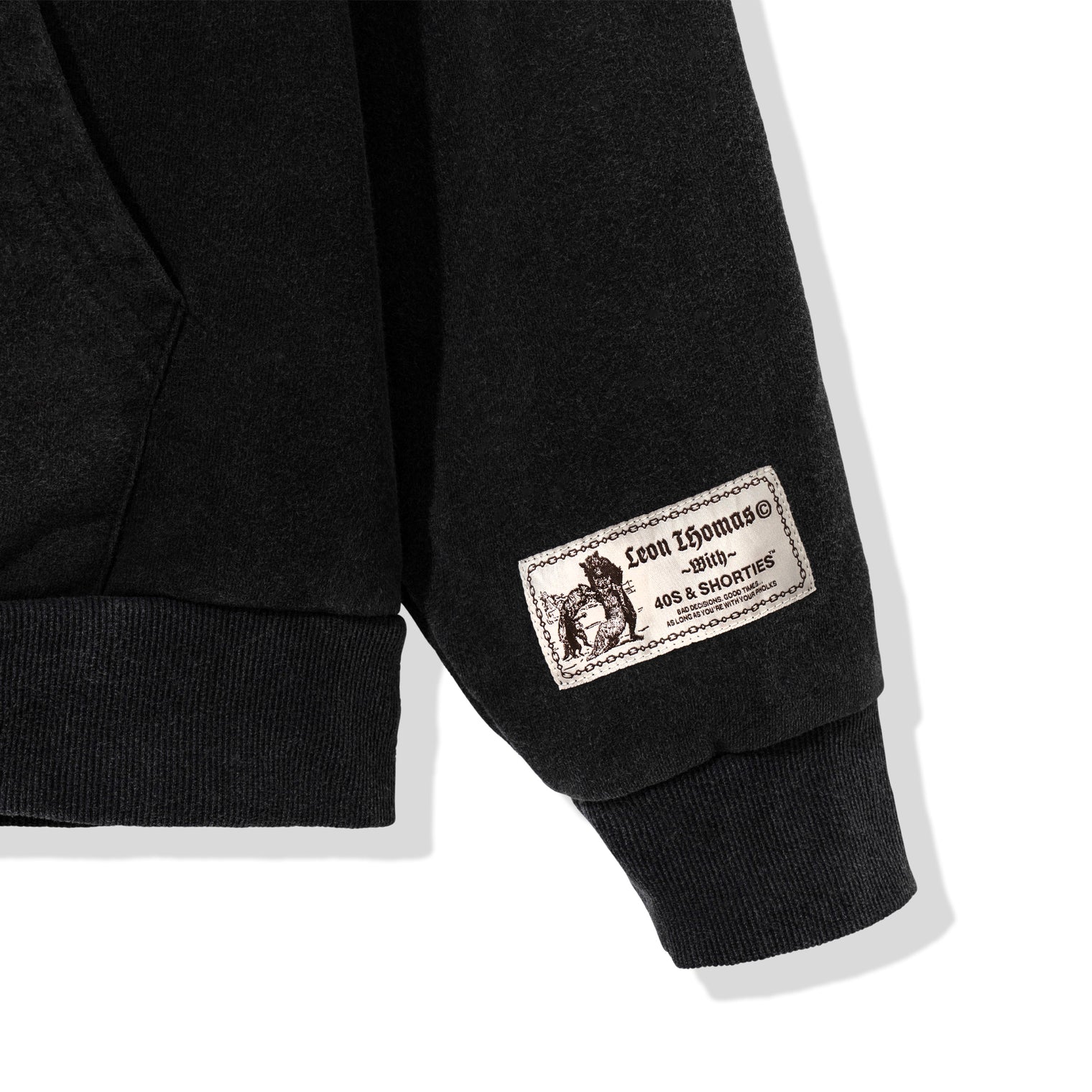 Close-up of sleeve woven collaboration label on Triple Zip Hoodie