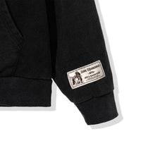 Close-up of sleeve woven collaboration label on Triple Zip Hoodie