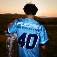 Model showing back view of Fubar Jersey in Blue with “FUBAR” and “40” appliqué visible.