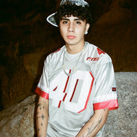 Angled close-up of model in the Fubar Jersey Grey, emphasizing mesh texture and chest embroidery.