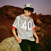 Male model wearing the Fubar Jersey in Grey, showing front appliqué.
