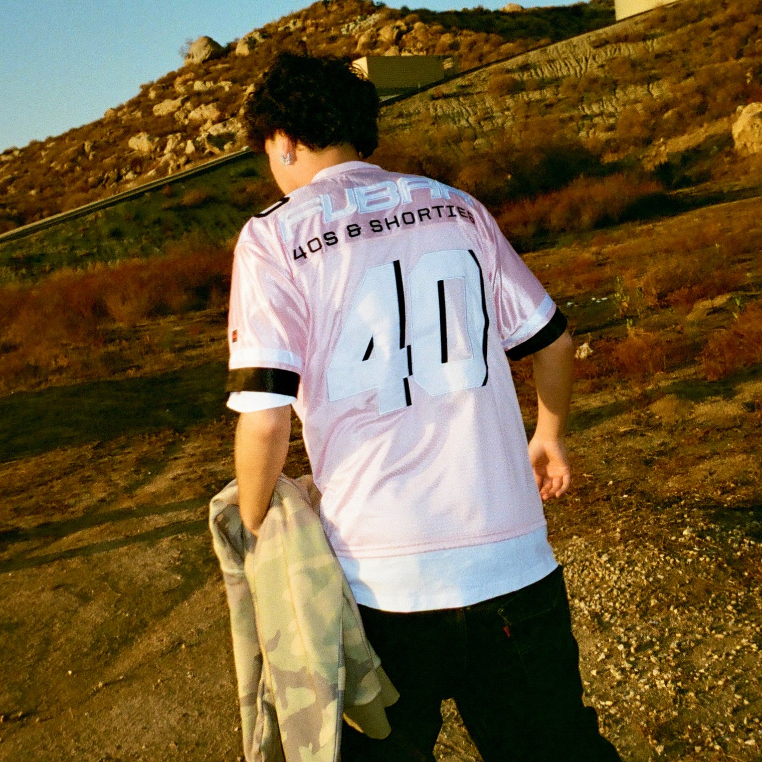 Model showing back view of Fubar Jersey in Pink with “FUBAR” and “40” appliqué visible.